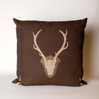 A Brown pillow with a Deer Antler Design