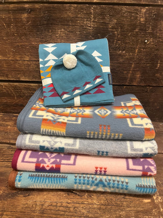 Multiple Pendleton Baby Blankets Stacked with a Beanie on top